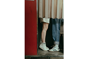 couple's feet behind a curtain