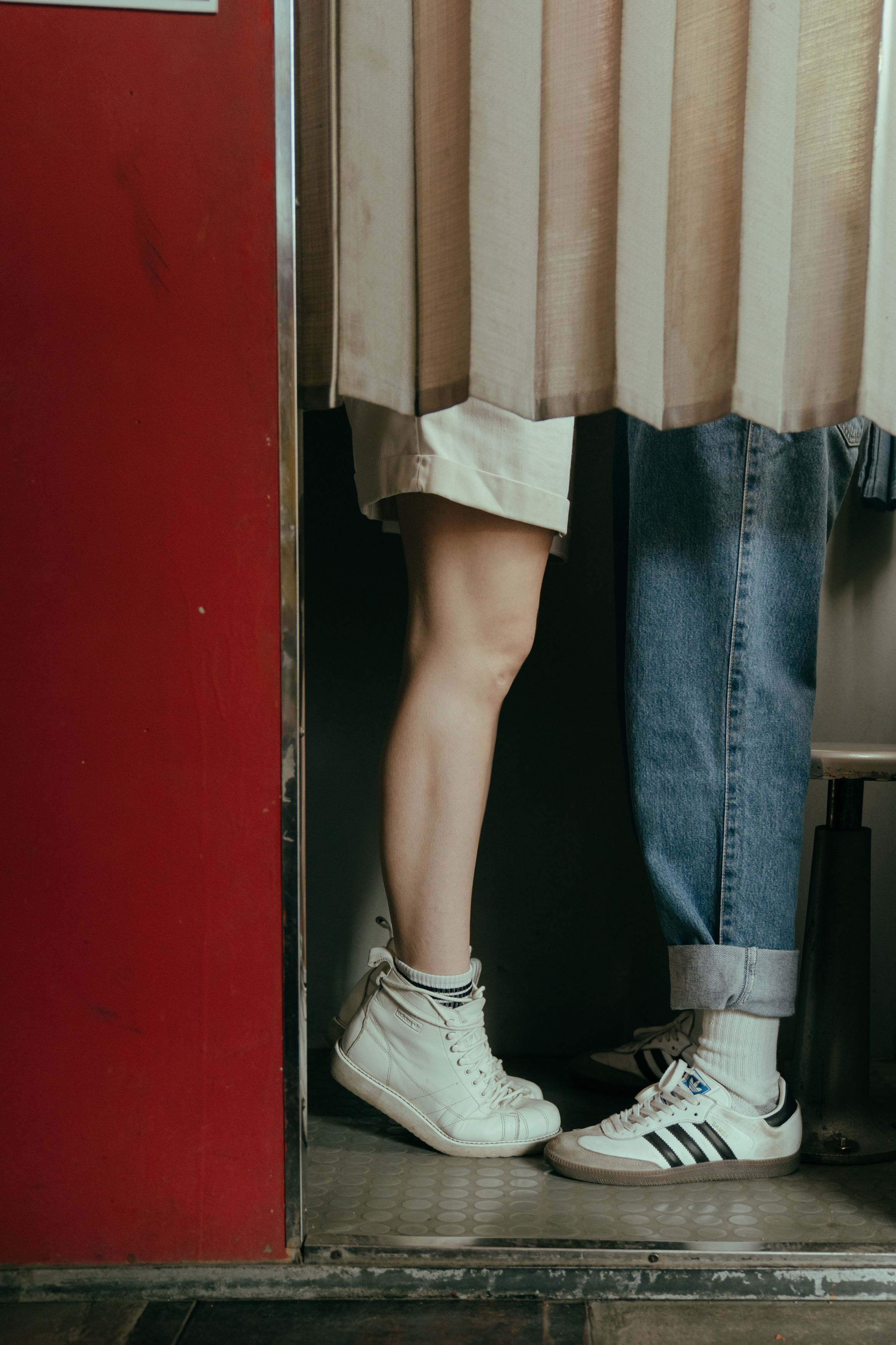 couple's legs behind a curtain