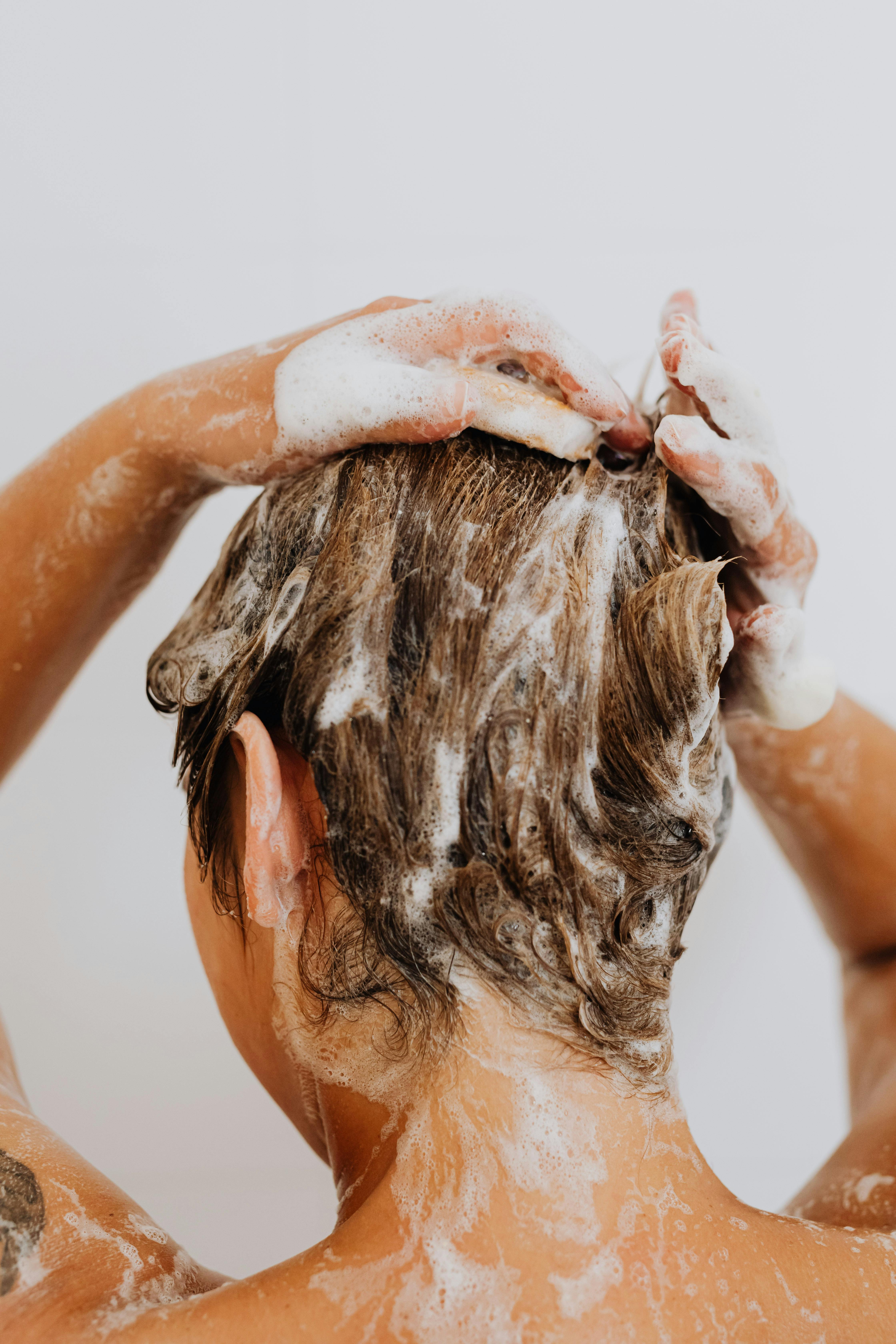 blond man washing his head