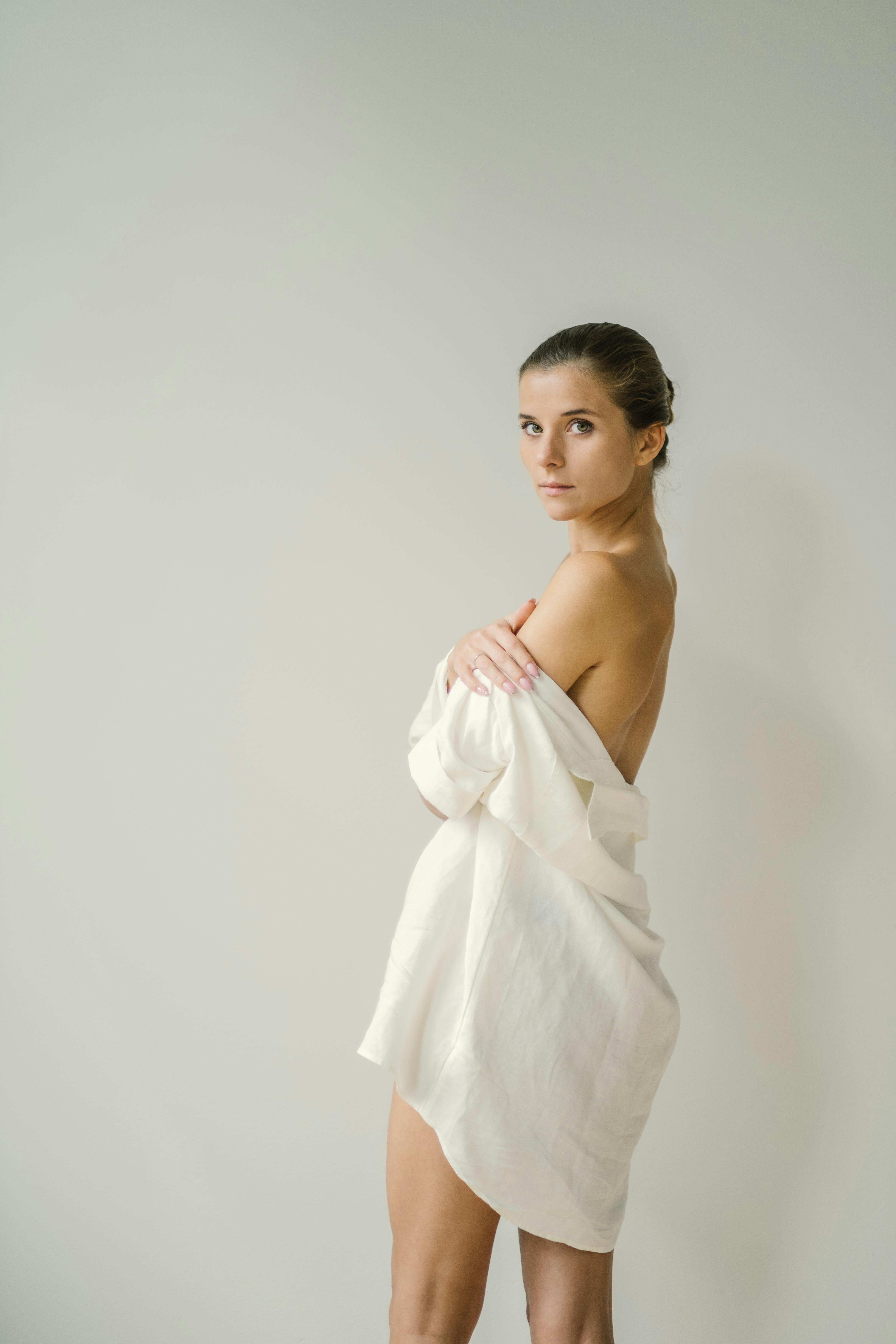 blond woman in white sheets facing the camera